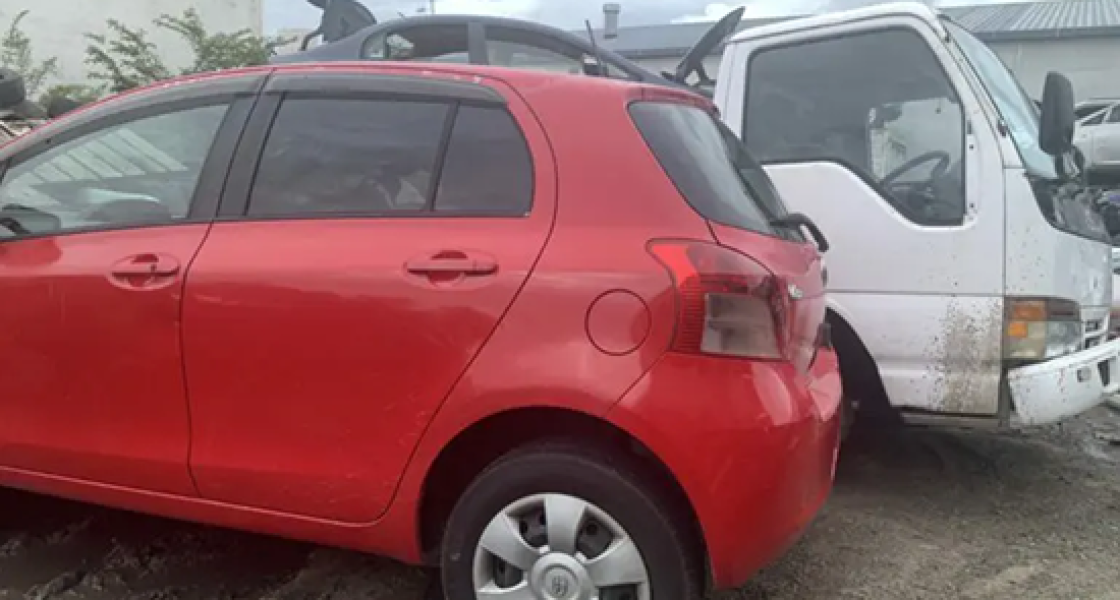 Scrap car parked next to a Cash For Cars Whangarei tow truck